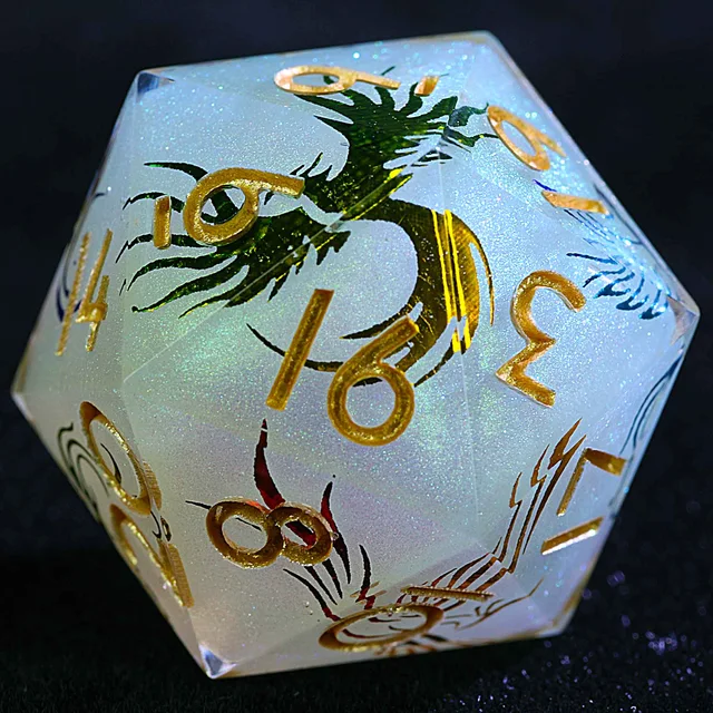 Close-up of a pale blue-white glittering D20 with gold numbers and a green dragon design.