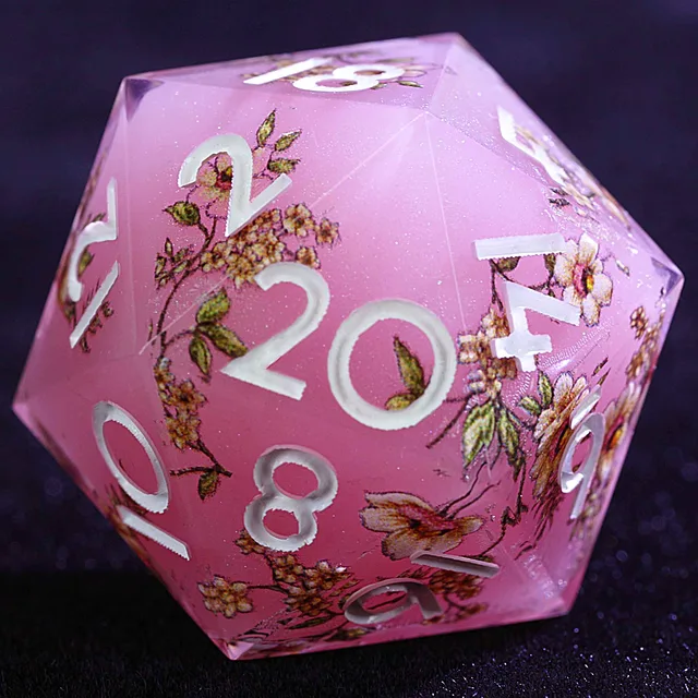Close-up of a pink-purple floral D20 with white numerals.