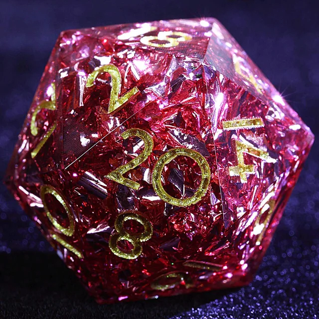 Close-up of a crimson-pink D20 with reflective flecks and gold-coloured numerals.