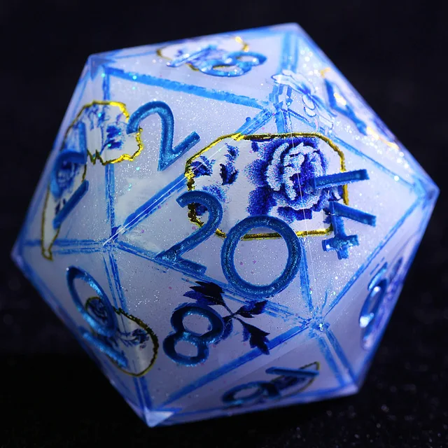 Close-up of a frosty white D20 with blue numerals, blue flowers, and gold outlines.