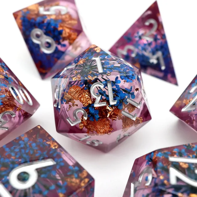 Close-up of a pink-purple D20 with blue flowers and copper-coloured flecks.