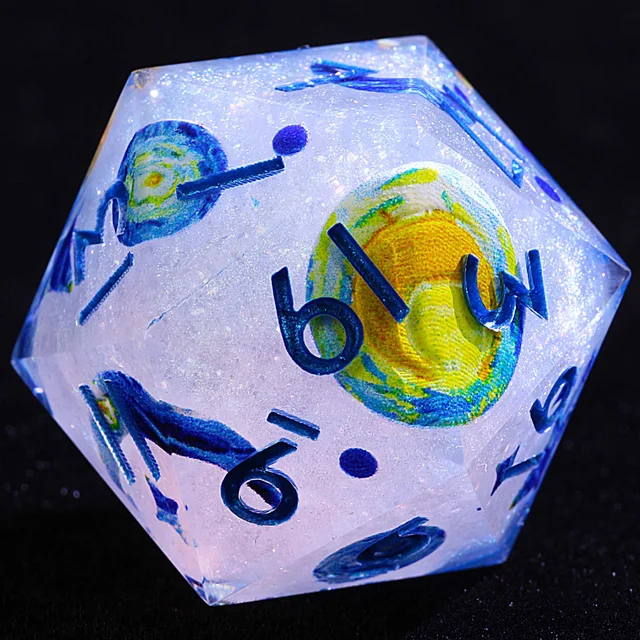Close-up of a glittery pale die with blue numbers and a yellow-and-blue swirling circular pattern.