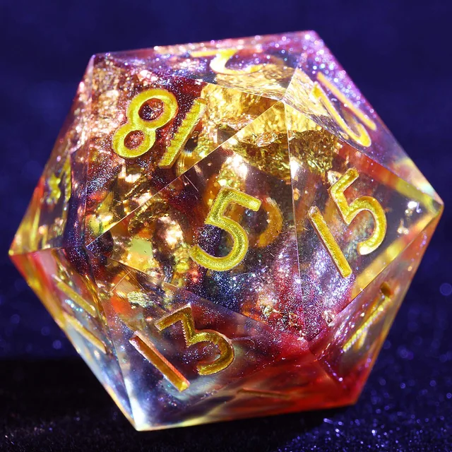 Close-up of a translucent red and amber D20 with dark shimmer, gold flecks and gold numerals.