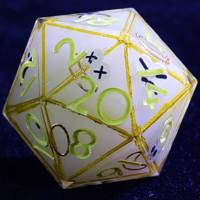 Close-up of a pale D20 with gold outlines and yellow-green numbers.