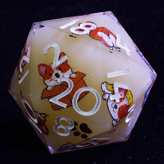 Close-up of a creamy glitter D20 with white numbers and corgi illustrations.
