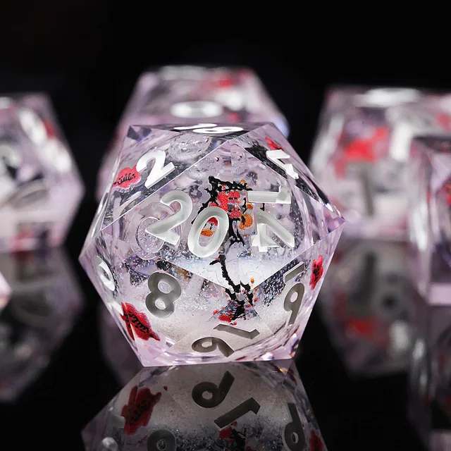 Close-up of a transparent lavender twenty-sided die with white numerals and red blossoms.