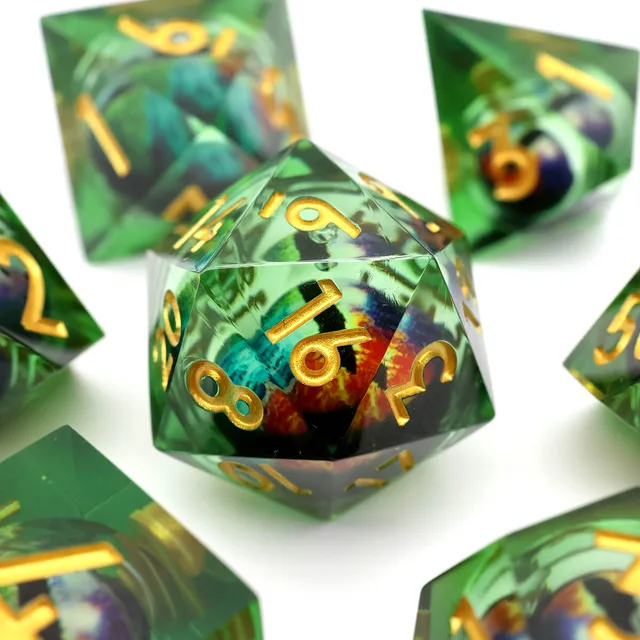 Close-up of a green twenty-sided die with gold numbers and a multicoloured centre.