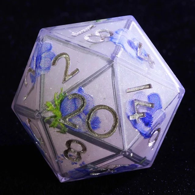 Close-up of a pale lavender D20 with blue flowers, green foliage and silver numbers.