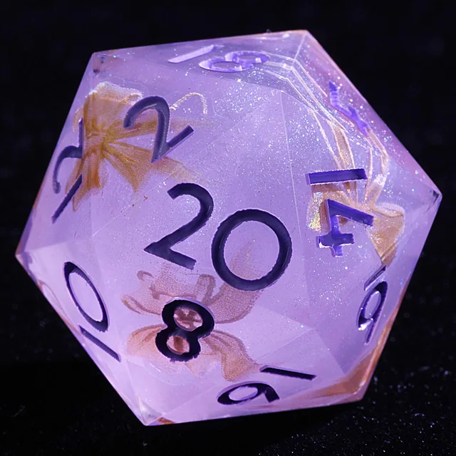 Close-up of a lilac D20 with purple numerals, fine sparkle and gold bow inclusions.