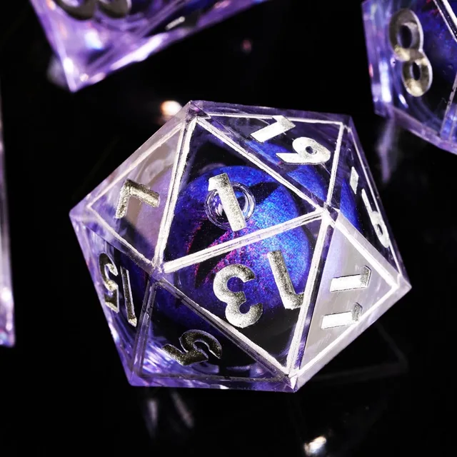 Close-up of a purple D20 with silver numbers and a shimmering blue-purple inner orb.
