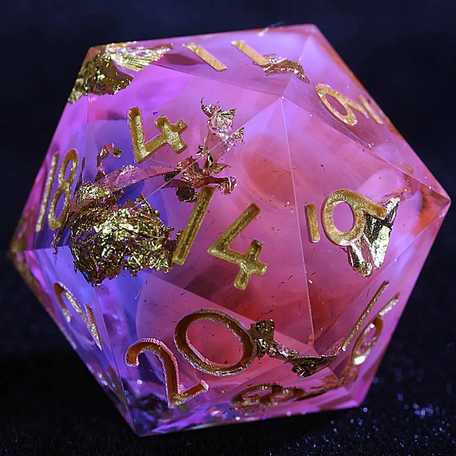 Close-up of a pink and violet D20 with gold foil and gold numerals.