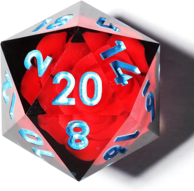 Close-up of a dark transparent D20 with a red flower and light-blue numbers.