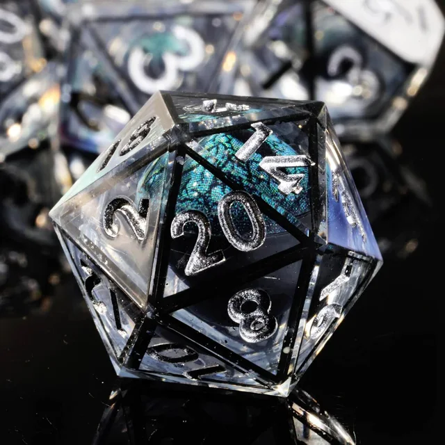 Smoky transparent D20 with a blue-green eye-like core, black face borders and silver numbers.