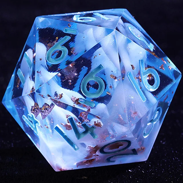 Close-up of a translucent blue D20 with white swirls, copper-gold flecks and pale blue-green numbers.