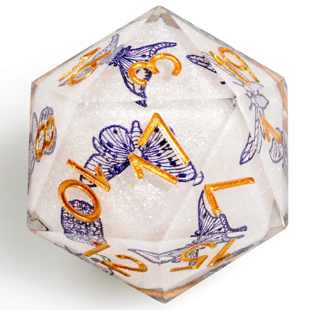 Close-up of a white D20 with blue butterfly illustrations and orange-gold numbers.
