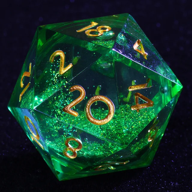Close-up of a transparent green glitter-core D20 with gold numbers.