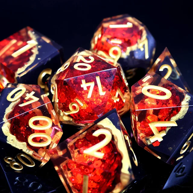 Close-up of red and black dice with gold numbers against a dark background.