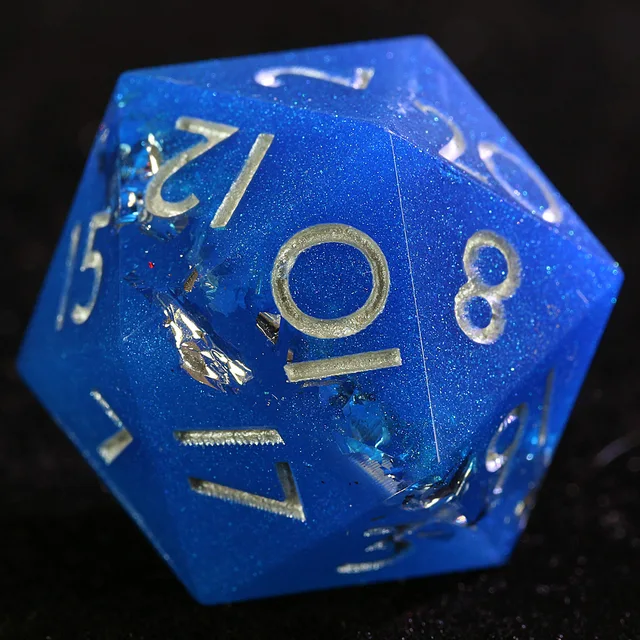 Close-up of a glittery blue D20 showing silver-coloured numbers and reflective foil.