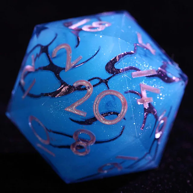Close-up of a blue D20 with dark swirling veins, glitter flecks and pale pink numerals.