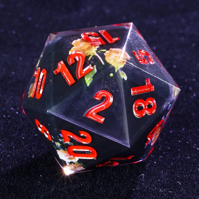 Close-up of a black floral D20 with clear edges and red numbers.