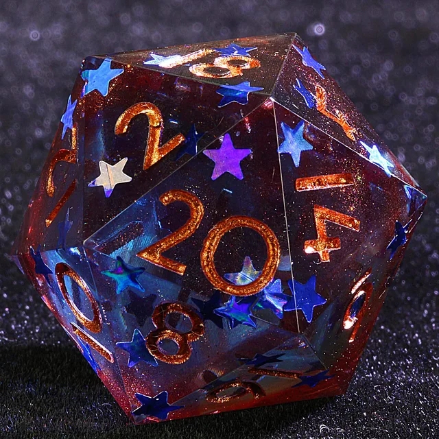 Close-up of a red and blue glittering D20 with gold numbers and colourful star inclusions.