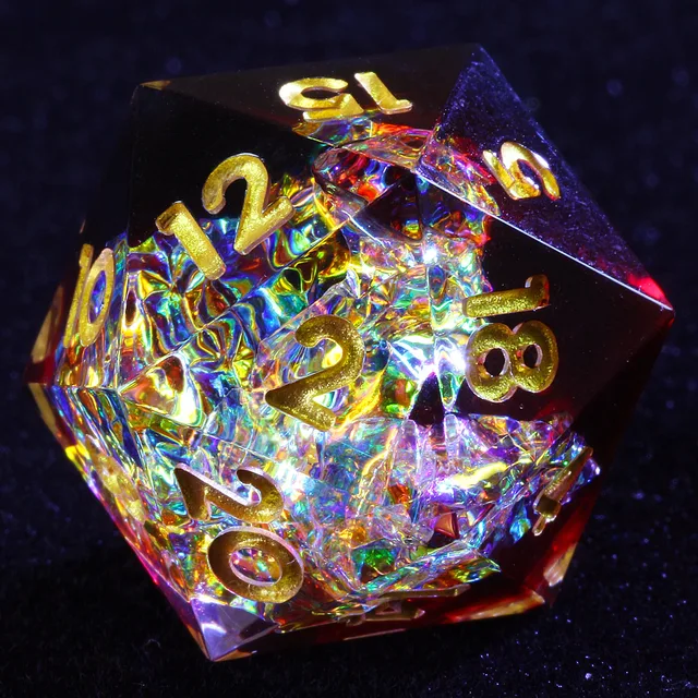 Close-up of a red and clear D20 with iridescent foil and gold numerals.