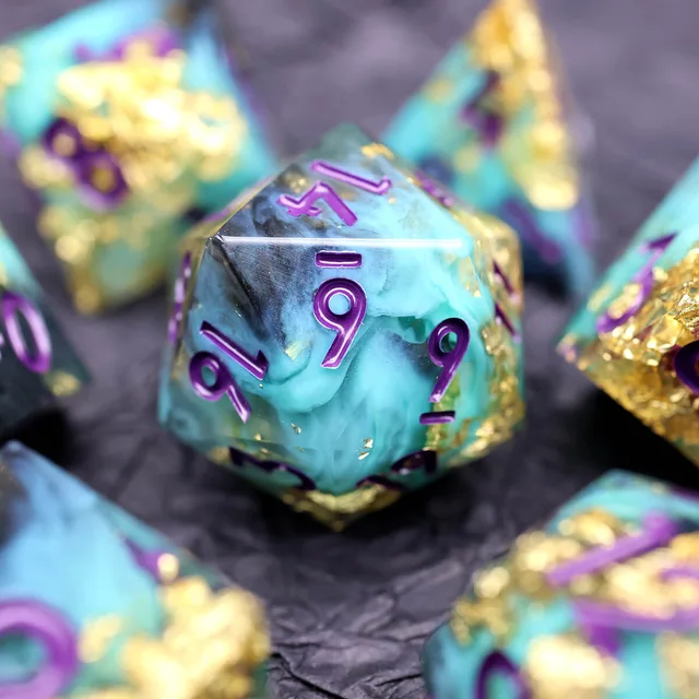 Close-up of a turquoise and smoky black D20 with purple numerals