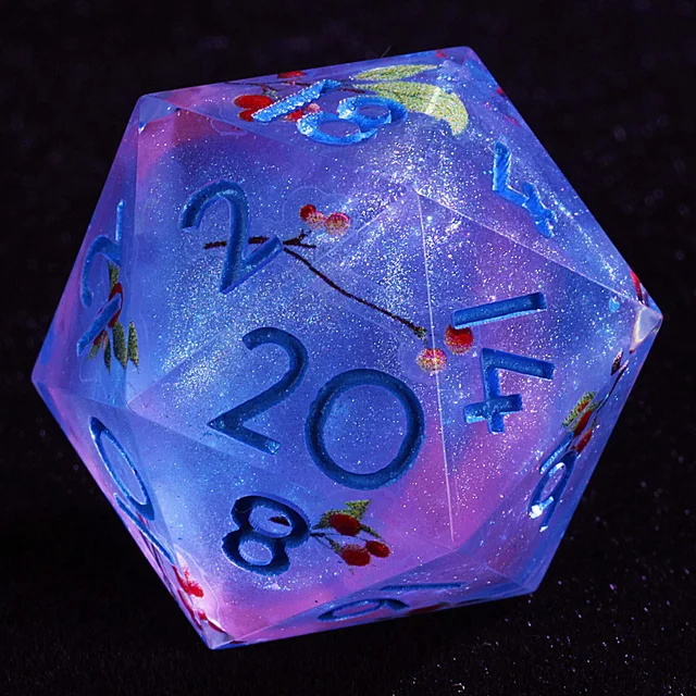 Close-up of a glittering lavender and pink D20 with blue numbers and red cherry designs.