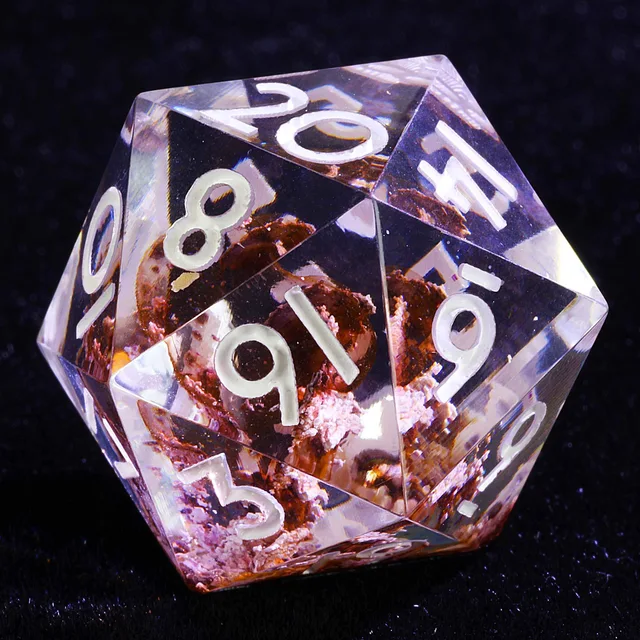Close-up of a clear D20 with caramel-brown inclusions and white numbers.