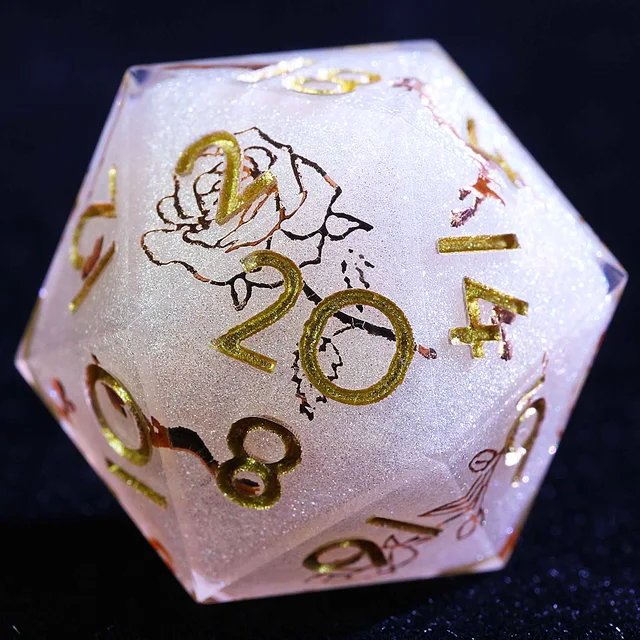 Close-up of a shimmering pale D20 with gold numbers and a rose illustration.