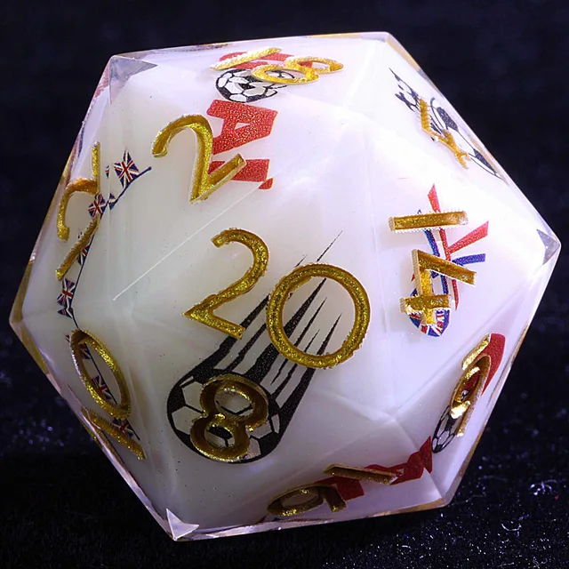 Close-up of a white D20 with gold numbers, Union Jack details, and a football graphic.