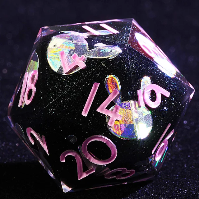Close-up of a black glitter D20 with pink numbers and iridescent rabbit silhouettes.