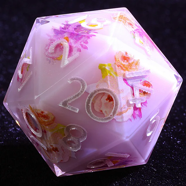 Close-up of a pale pink-lilac D20 with silver-toned numbers and pink, orange and yellow patterns.