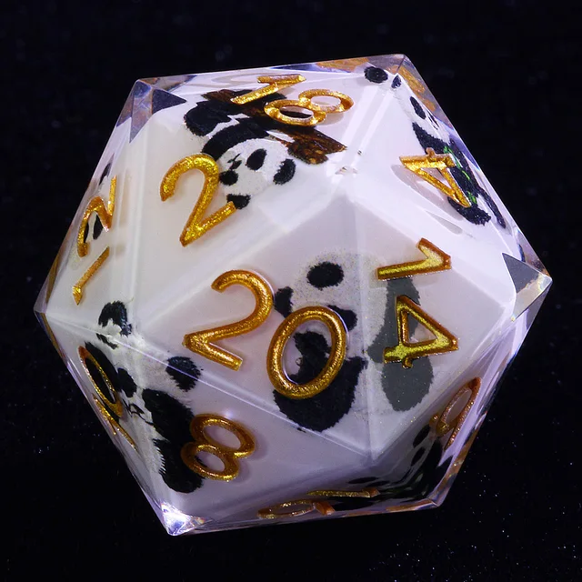 Close-up of a panda-patterned milk-white D20 with gold numbers and clear edges.