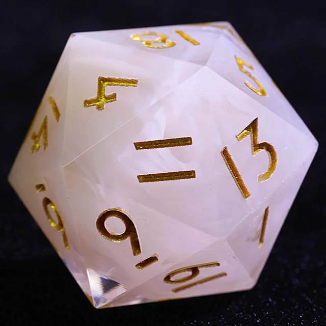 Close-up of a translucent white-cloud D20 with gold numbers.
