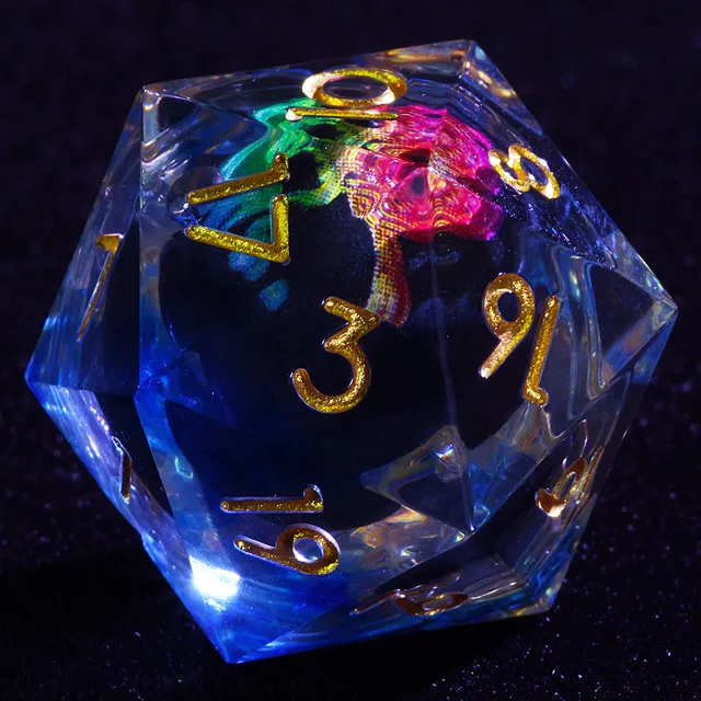 Close-up of clear D20 with gold numbers and a pink and green skull core.