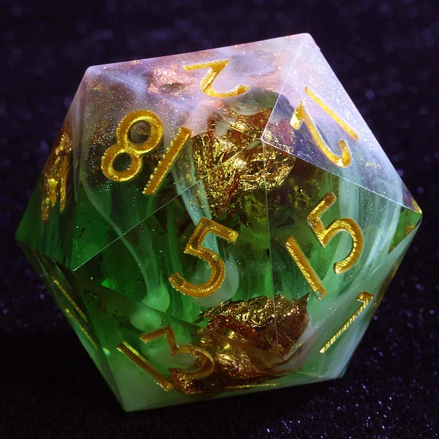 Close-up of a green and white swirled polyhedral die with gold numerals and flecks.