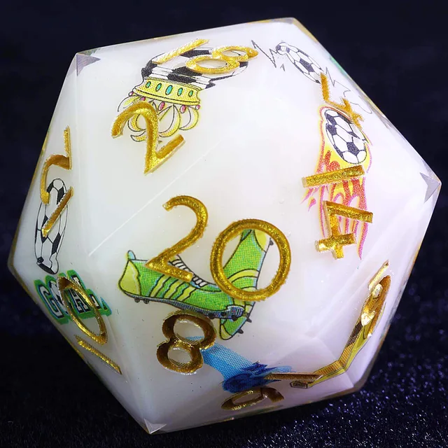 Close-up of a white D20 with gold numbers and colourful football illustrations