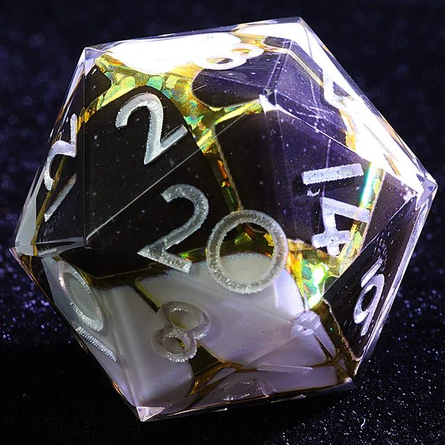 Close-up of a black and white D20 with gold accents and pale numbers.