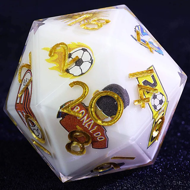 Close-up of a white-centered die with gold numbers, football graphics, and club branding.