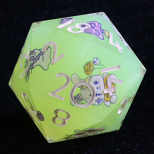 Close-up of a mint-green D20 with pale numerals and bunny illustrations.