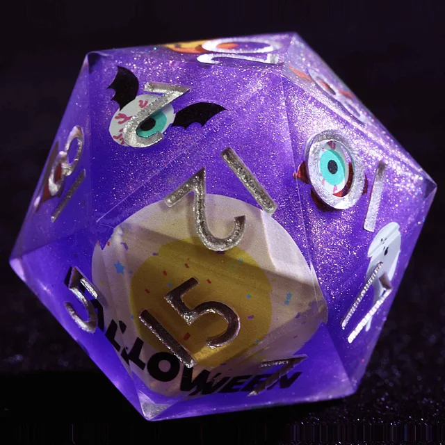 Close-up of a purple glitter D20 with silver-coloured numbers, eyeballs, bats and a yellow centre design.