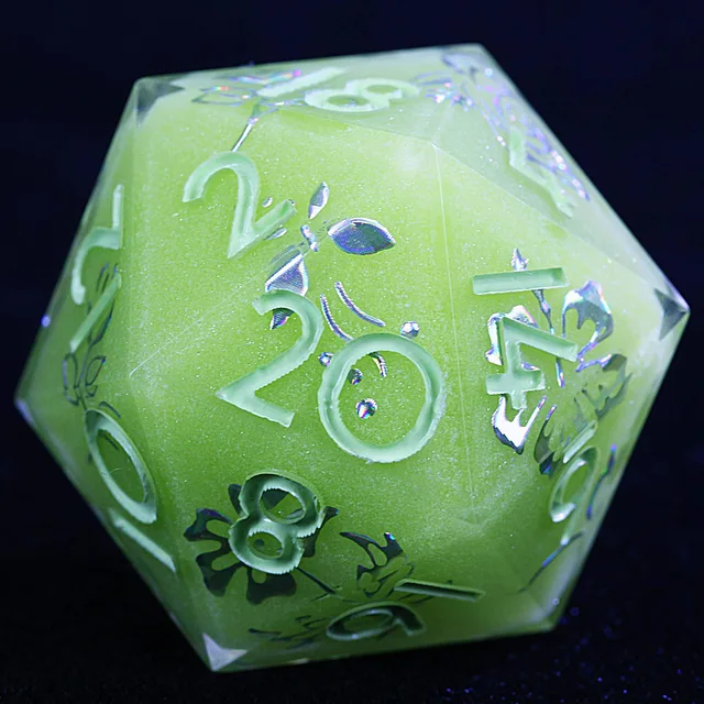 Close-up of a chartreuse-green D20 with pale numbers and iridescent floral detailing.