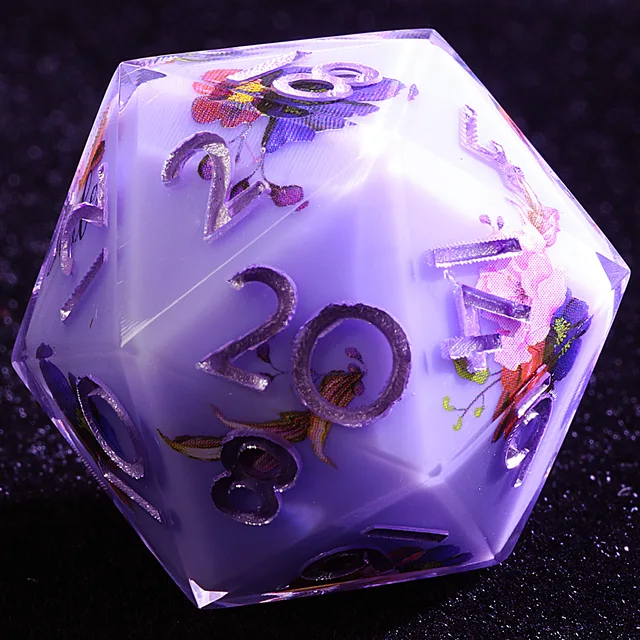Close-up of a pale lavender-white floral D20 with raised silver-coloured numbers.