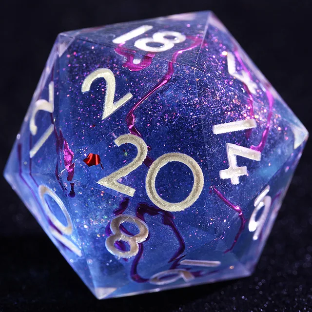 Close-up of a glittering blue-violet D20 with magenta streaks and pale gold numbers.