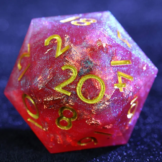 Close-up of a red and purple shimmering D20 with gold-coloured numerals and flakes.