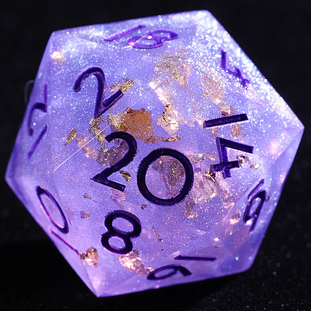 Close-up of a lavender-purple D20 with gold flakes, fine sparkle and dark numerals.
