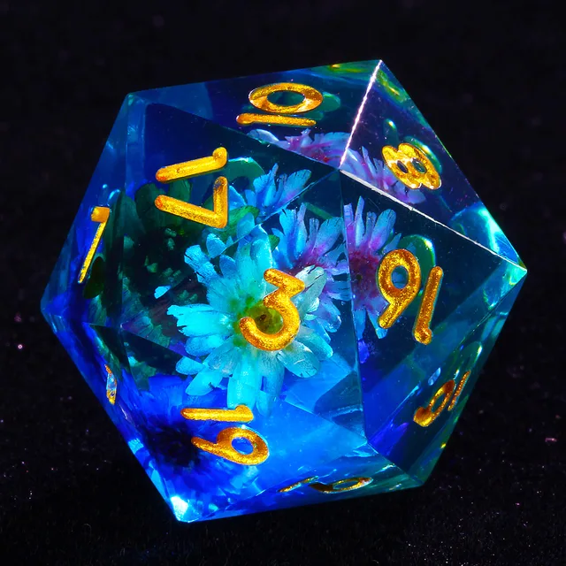 Close-up of a blue-tinted D20 with suspended flowers and gold numerals.