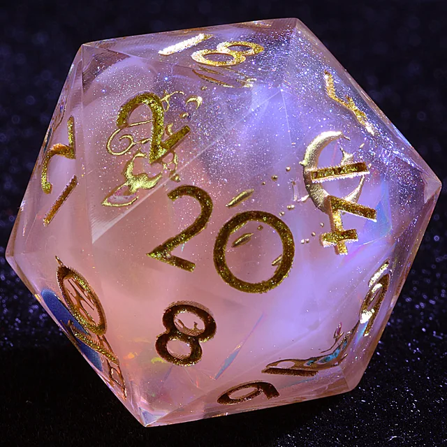 Close-up of a pale pink D20 showing its gold 20 face.
