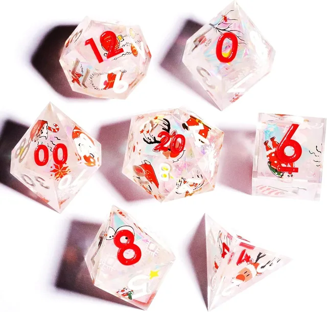 Overhead view of seven clear winter-themed dice on white.